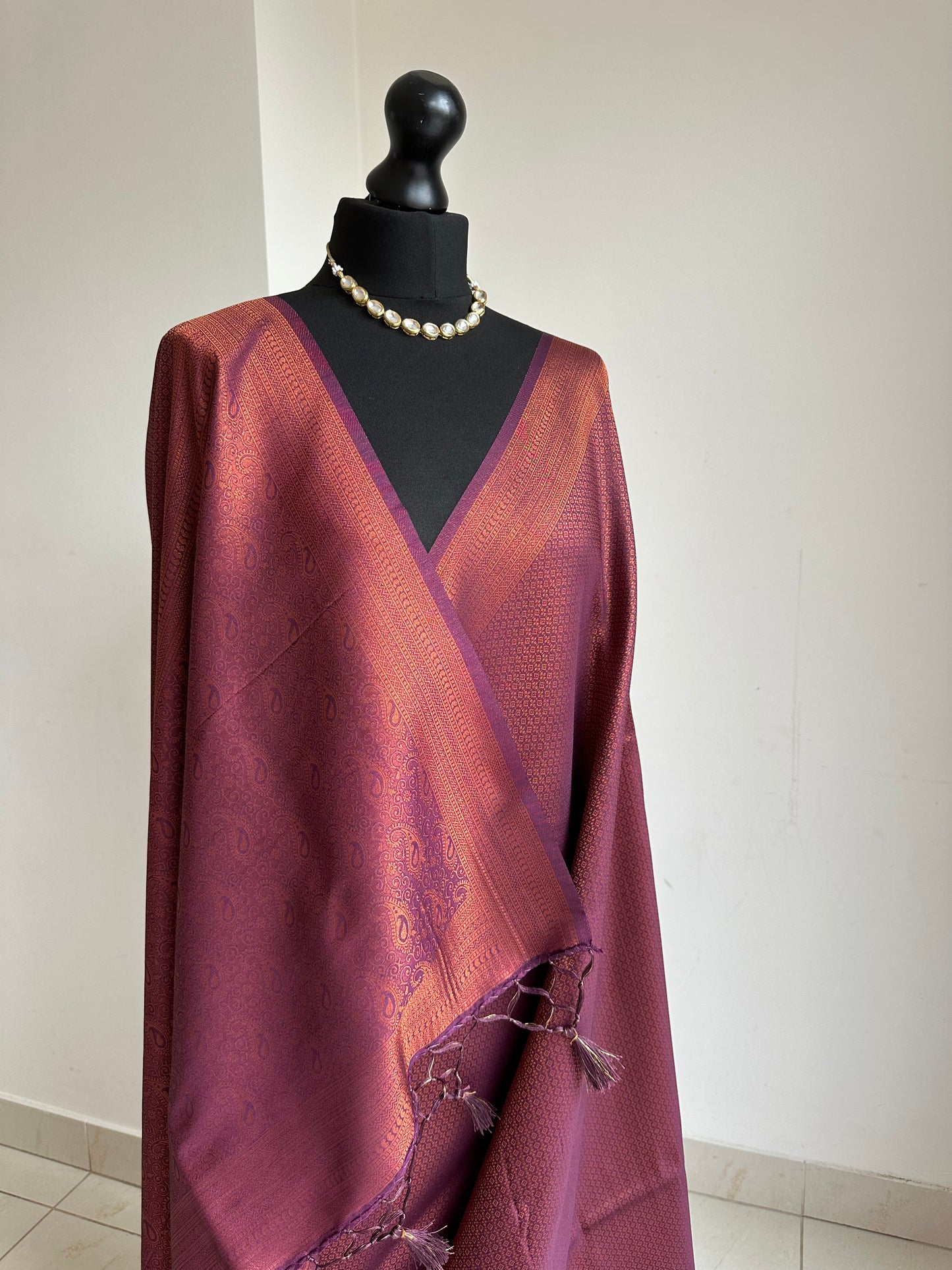 Wine burgundy soft silk saree with copper border and all over sheen. The perfect saree for parties all traditional events.Versatile saree