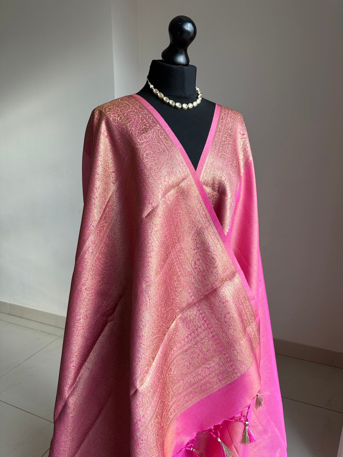 Pink and antique gold semi tissue silk saree. Unstitched brocade blouse.