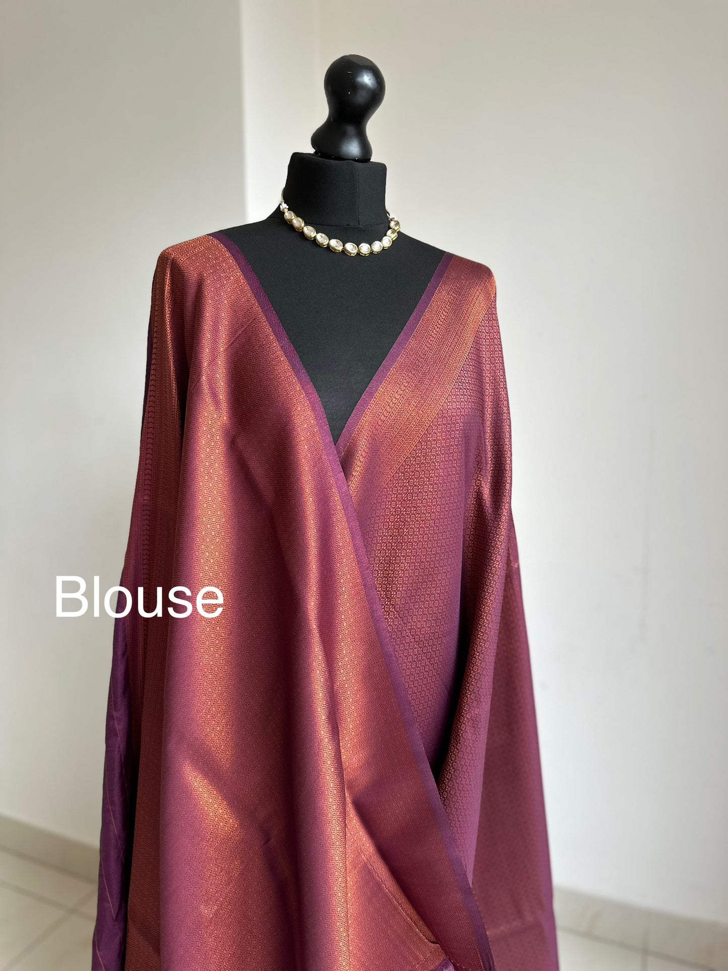 Wine burgundy soft silk saree with copper border and all over sheen. The perfect saree for parties all traditional events.Versatile saree