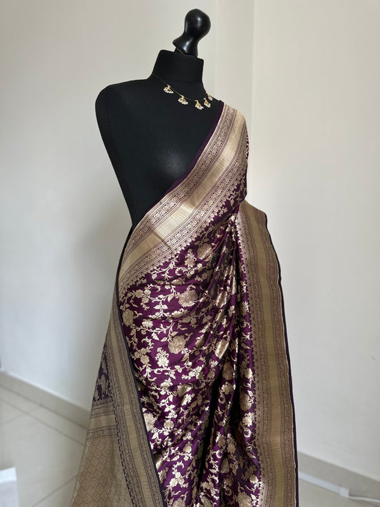 Elegant deep wine pure silk Banarasi saree with intricate gold zari work and floral motifs, perfect for weddings and festive occasions