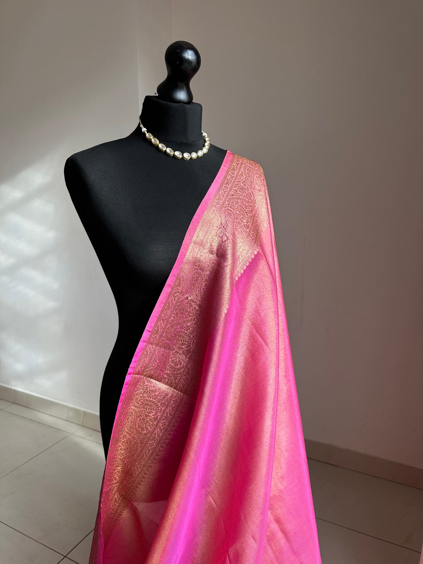 Pink and antique gold semi tissue silk saree. Unstitched brocade blouse.