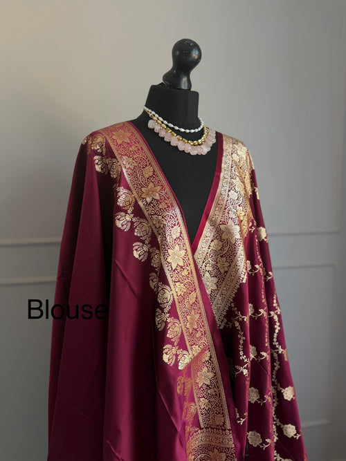 Wine satin finish Banarasi silk saree with intricate gold zari border and design