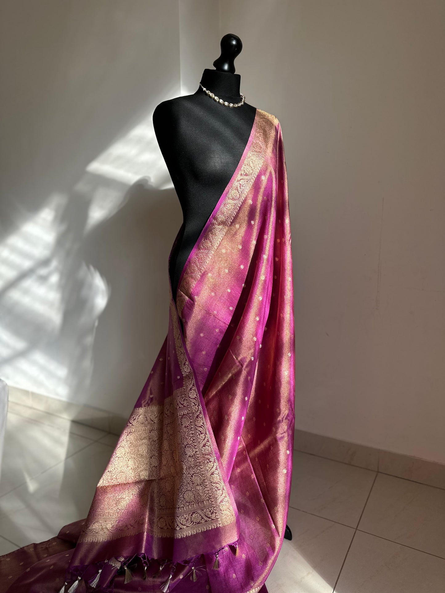 Dual tone magenta and gold semi tissue silk saree. Unstitched brocade blouse.