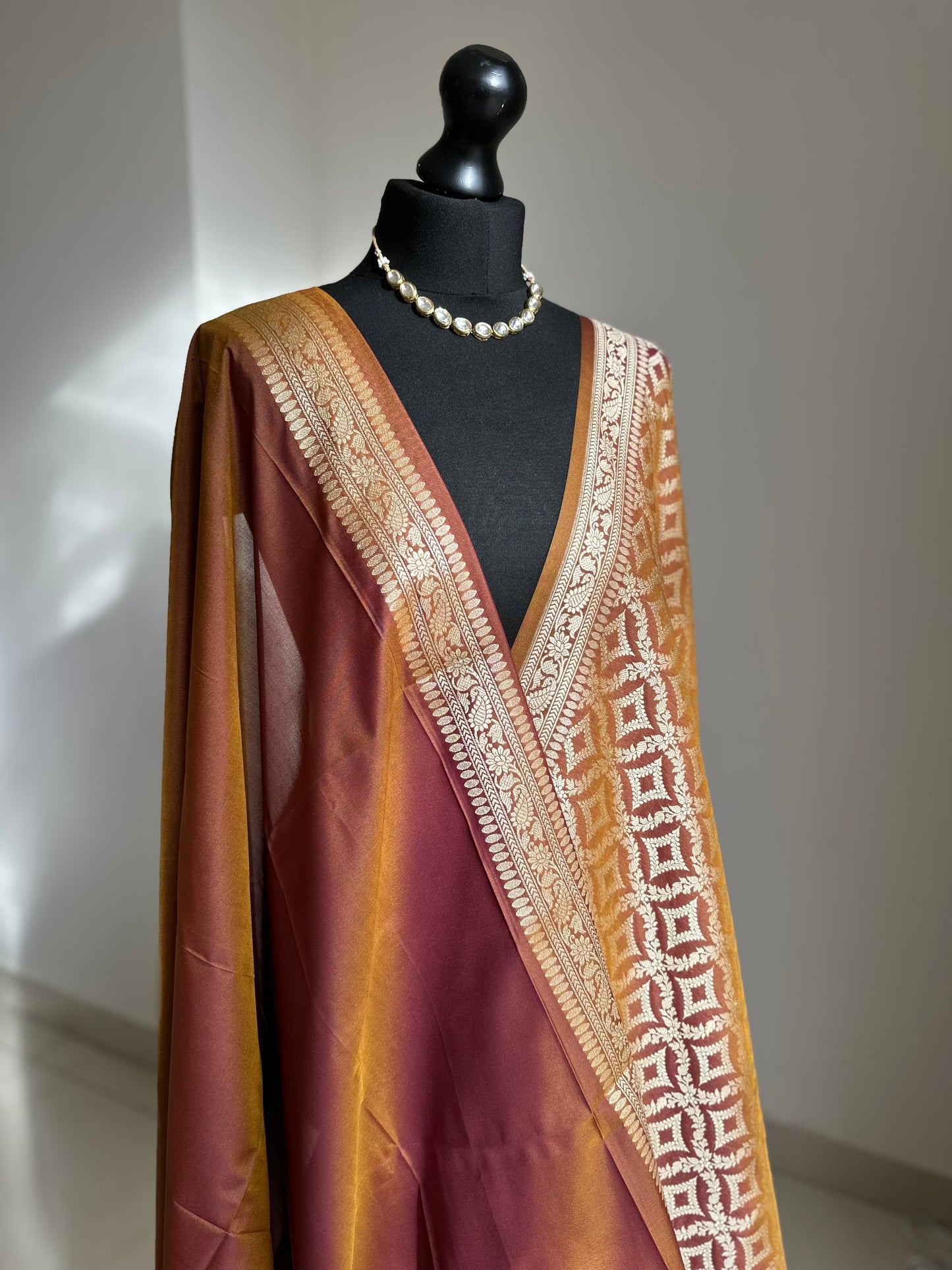 Dual-toned Banarasi silk saree in brown with golden mustard hues.
