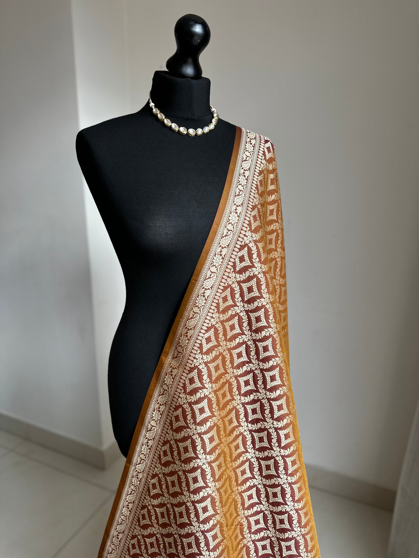 Dual-toned Banarasi silk saree in brown with golden mustard hues.
