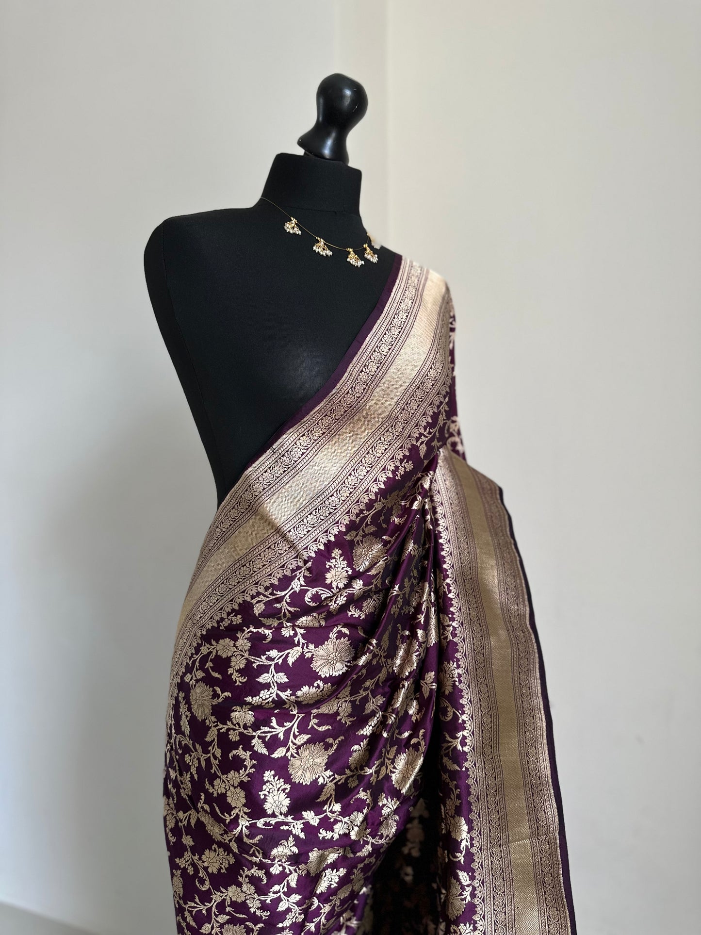 Elegant deep wine pure silk Banarasi saree with intricate gold zari work and floral motifs, perfect for weddings and festive occasions