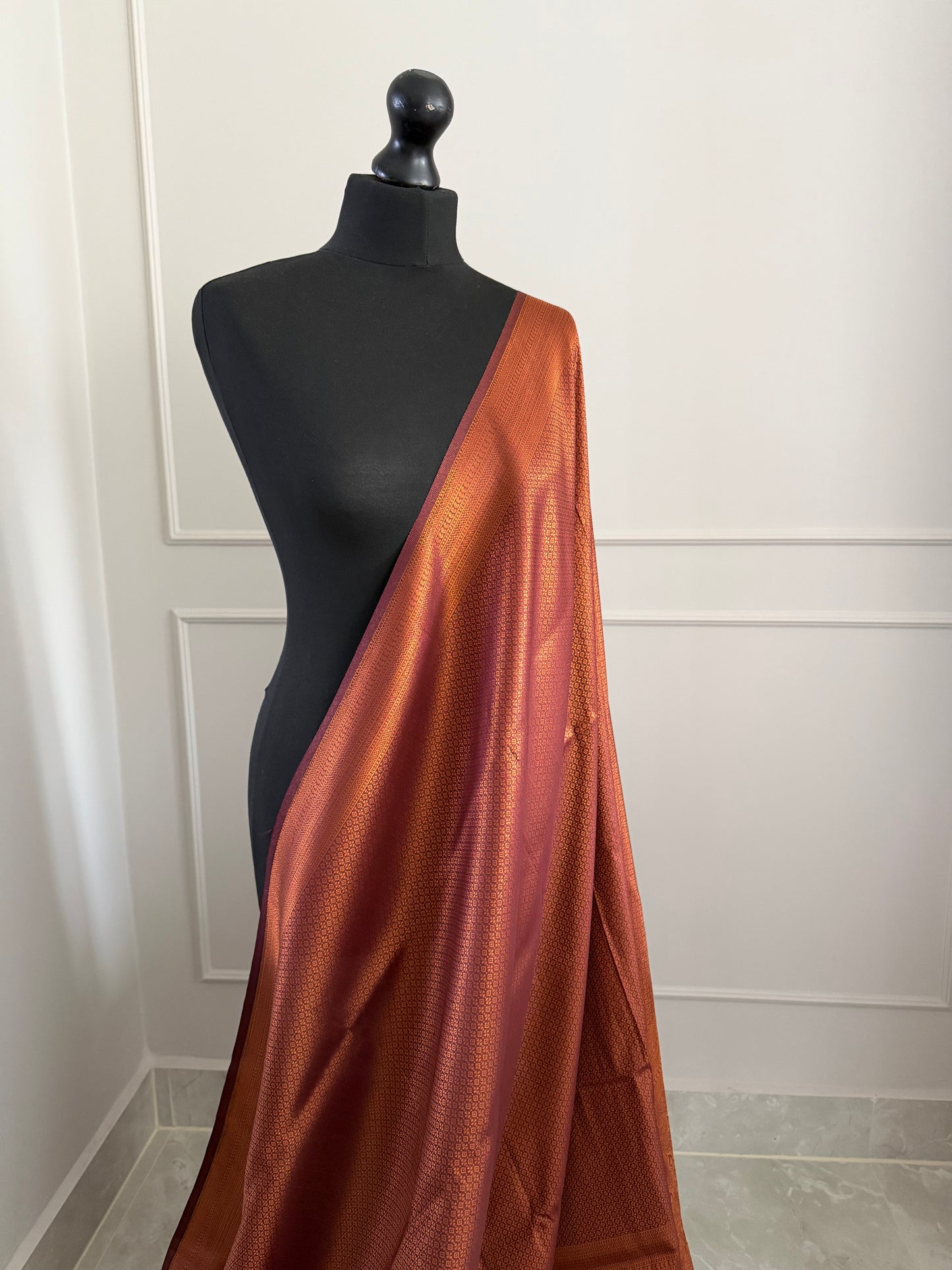 Chocolate brown copper soft silk saree with subtle border and all over sheen. The perfect saree for parties and all traditional events.