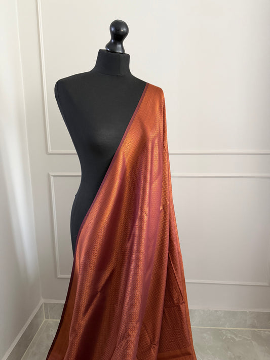 Chocolate brown copper soft silk saree with subtle border and all over sheen. The perfect saree for parties and all traditional events.