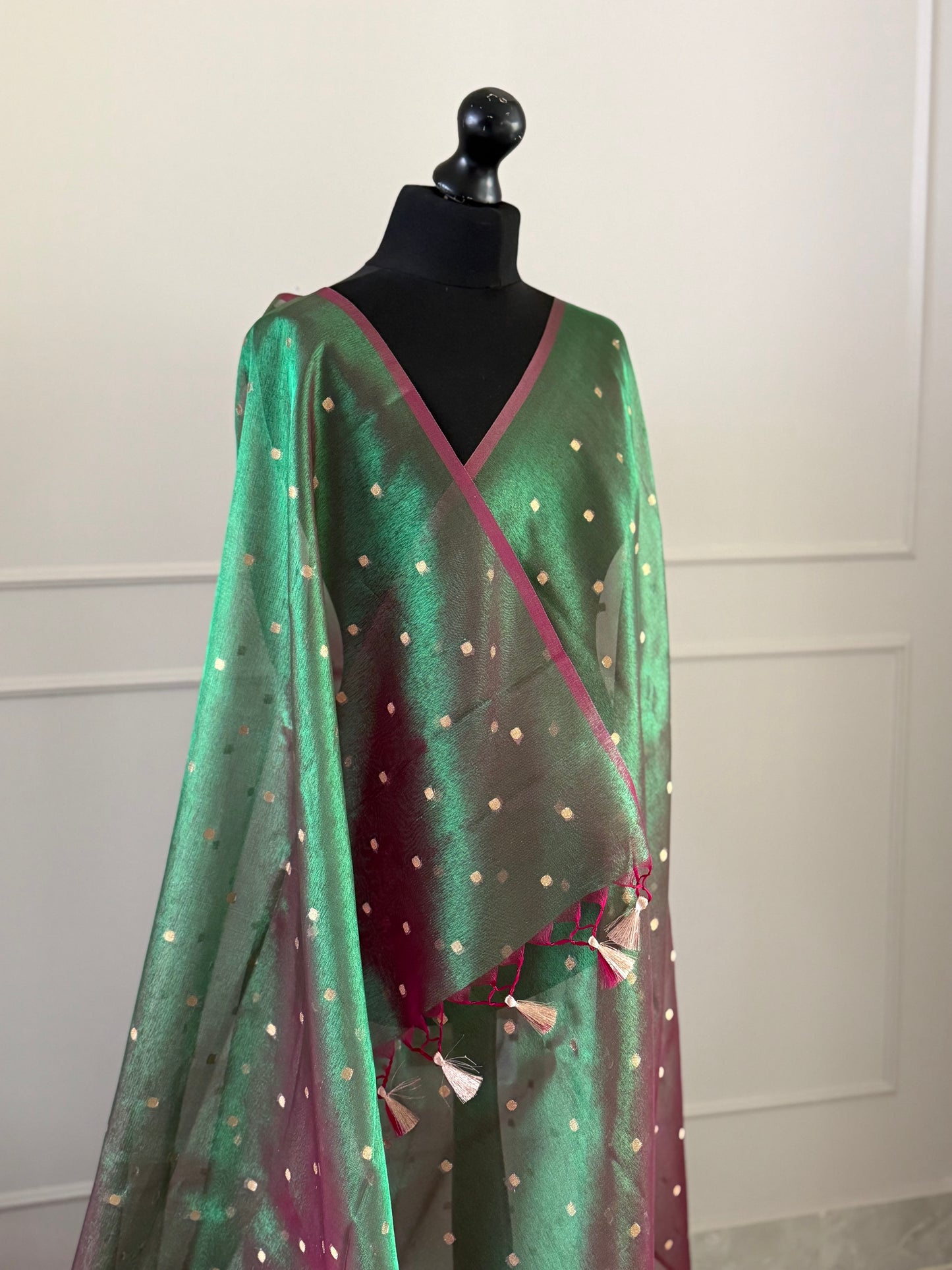 Statement handmade green and magenta dual tone soft tissue saree with unstitched blouse. Gold buti polka dot wedding saree. Unique saree look for events