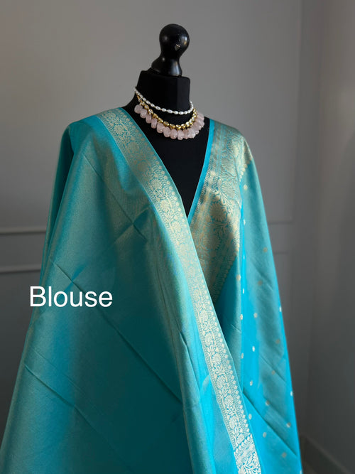 Turquoise blue firozi tissue silk saree with gold border and undertones.