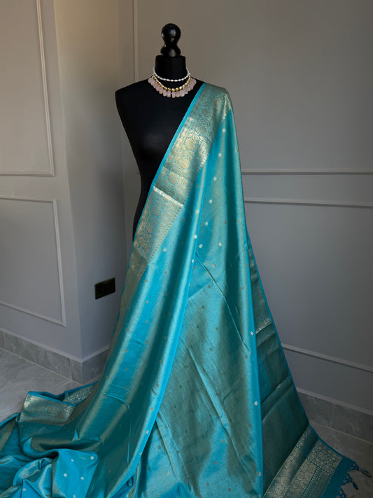 Turquoise blue firozi tissue silk saree with gold border and undertones.