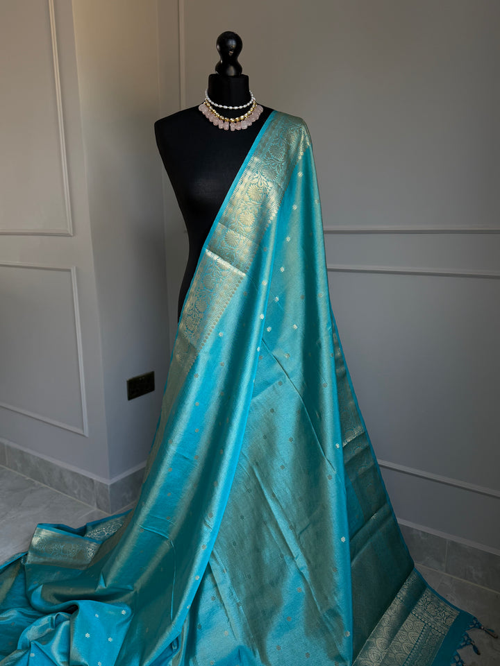 Turquoise blue firozi tissue silk saree with gold border and undertones.