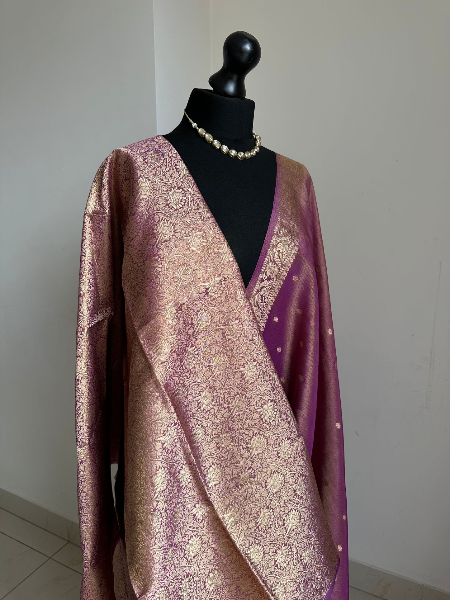 Dual tone magenta and gold semi tissue silk saree. Unstitched brocade blouse.