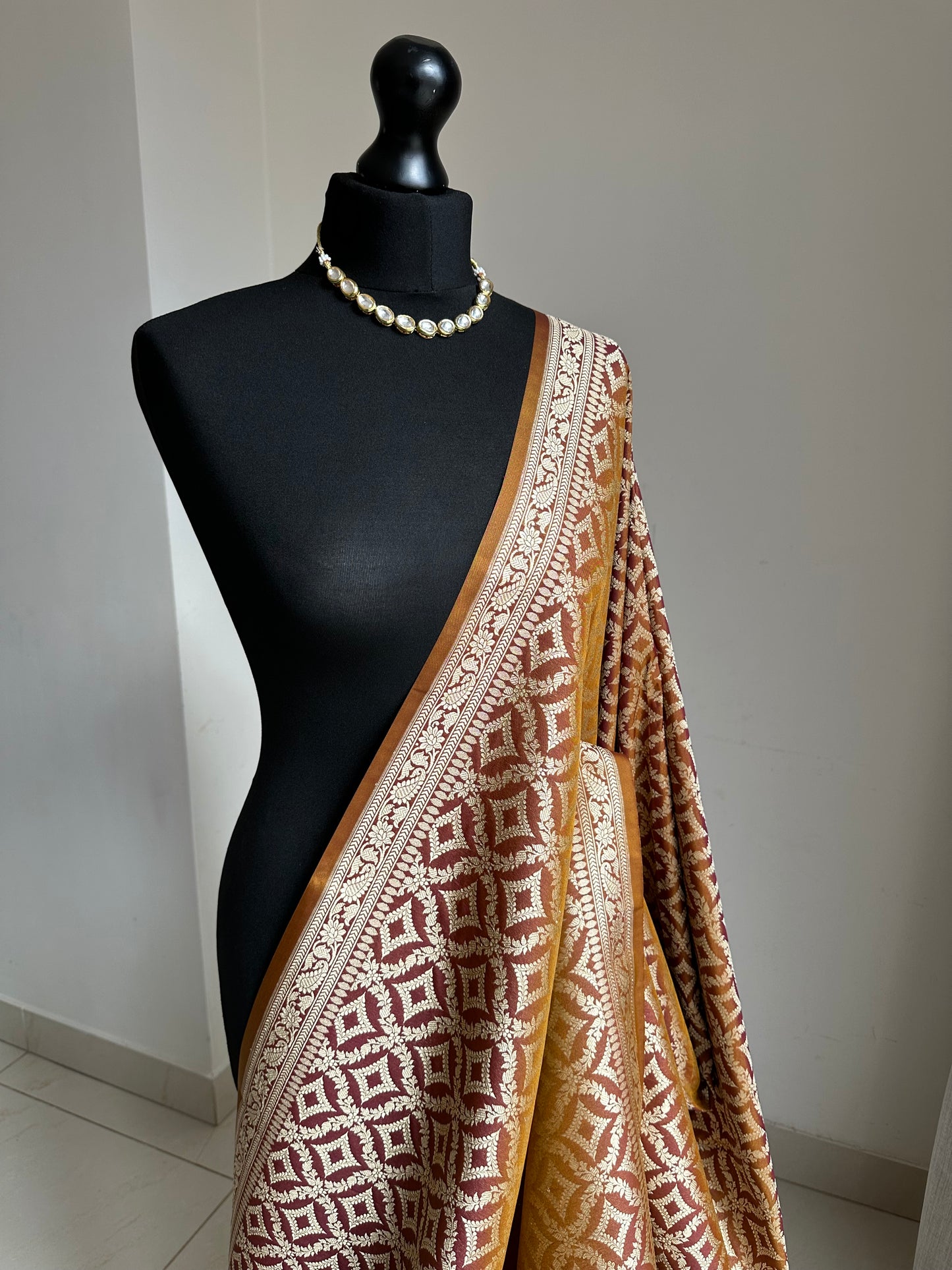 Dual-toned Banarasi silk saree in brown with golden mustard hues.