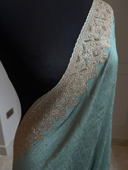 Teal georgette saree with antique gold stonework border