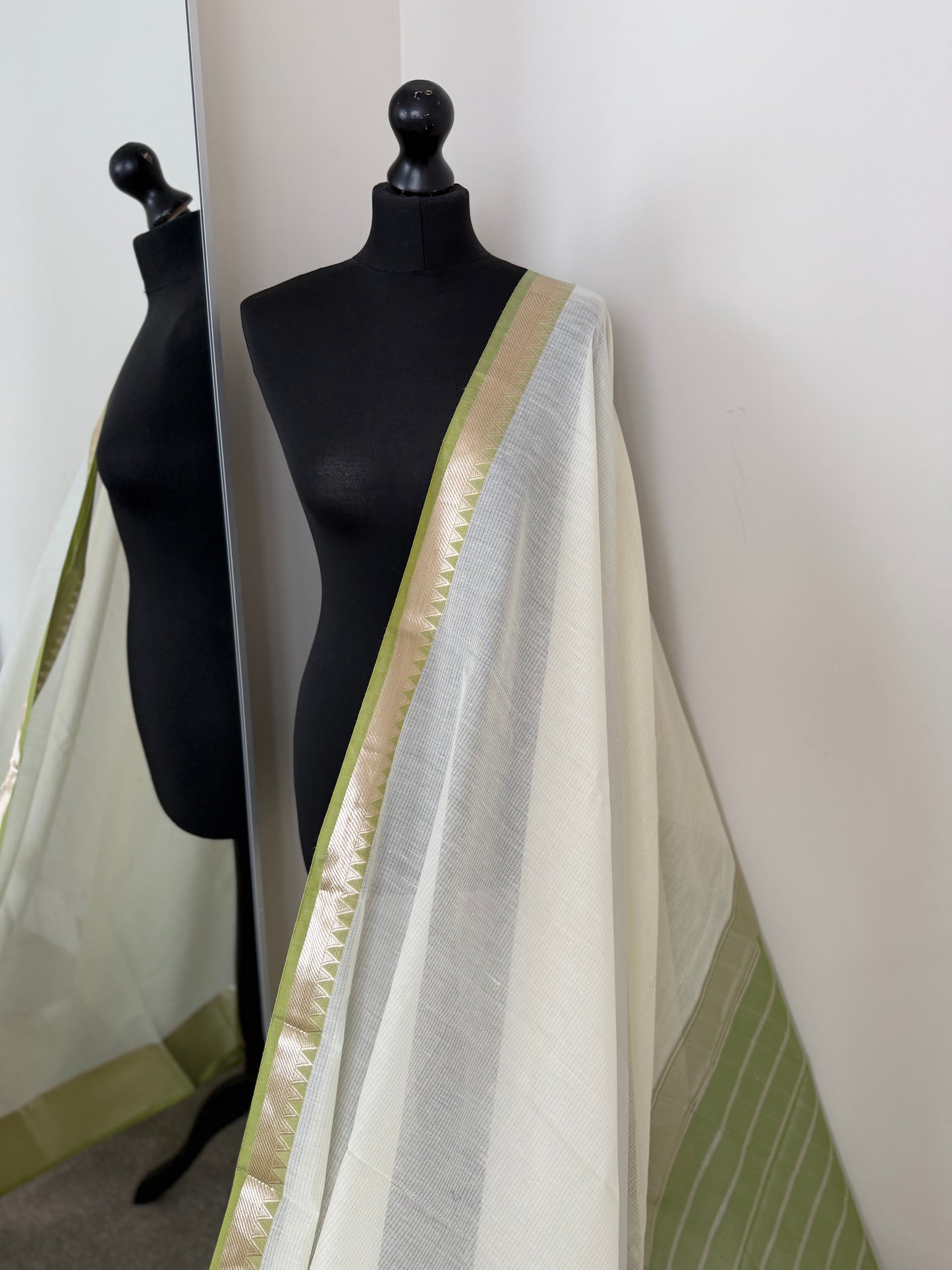 Elegant white cotton saree with green zari border