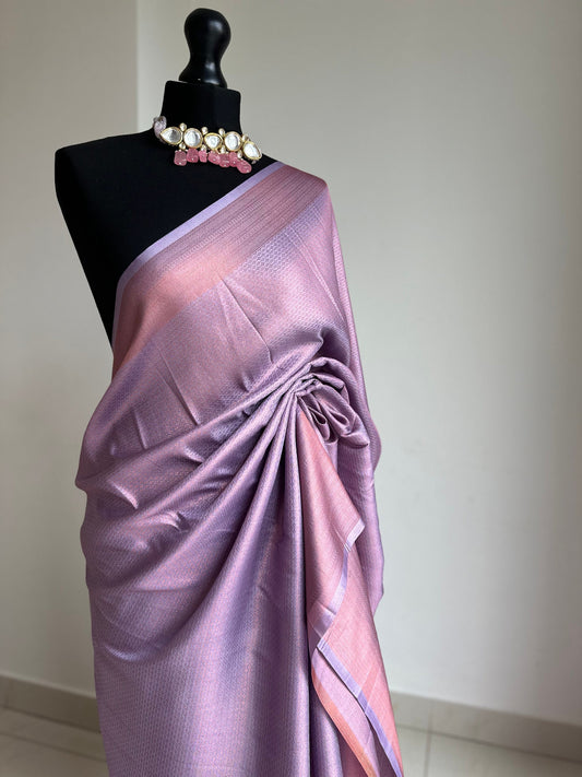 Lilac soft silk saree with a copper border and all over sheen. The perfect saree for parties and all traditional events. Versatile saree