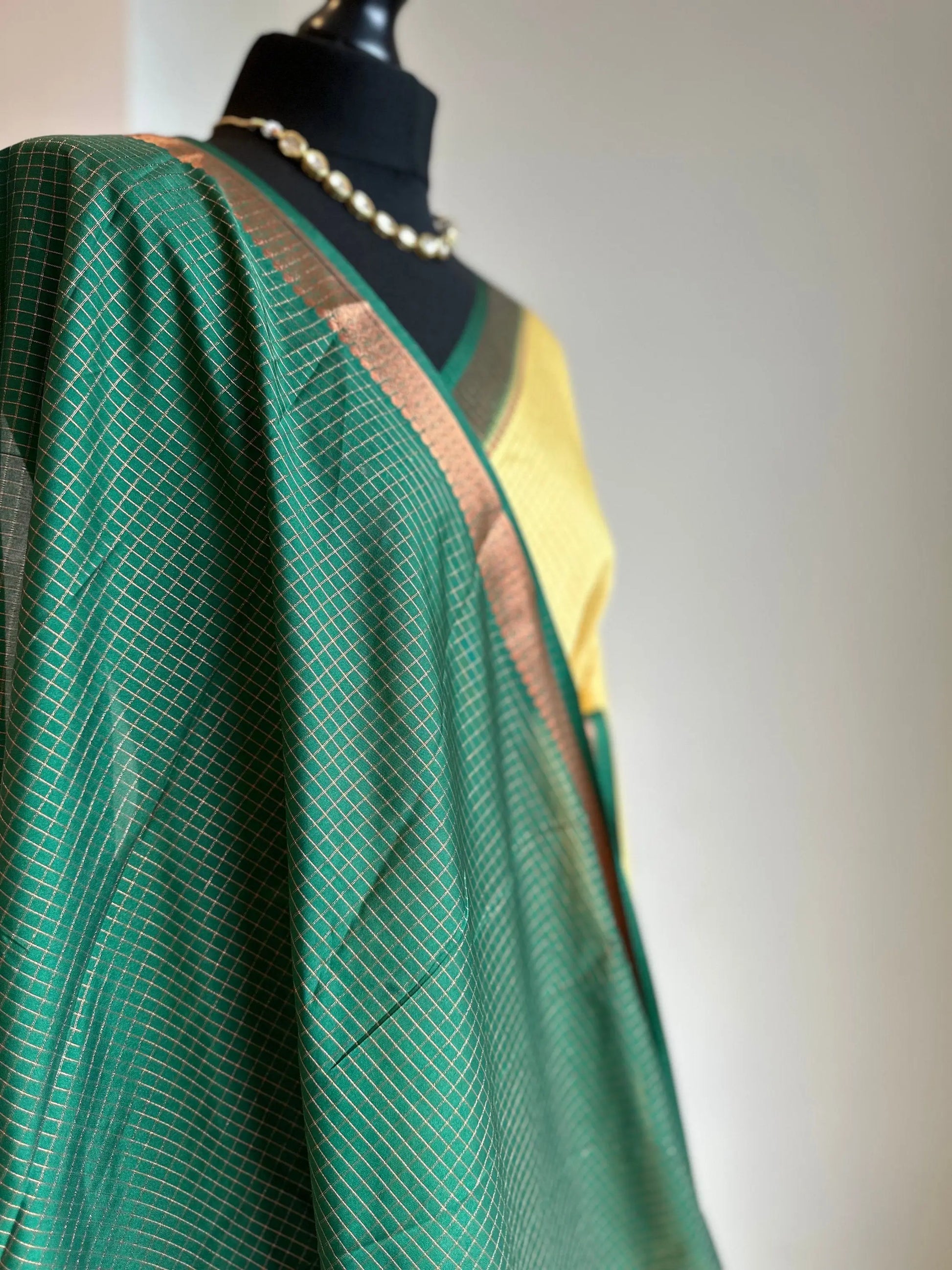 Yellow and green crepe binny silk saree with  contrast border, pallu and blouse. Beautiful checks  gives a stylish twist to this saree - LaiLai Sarees