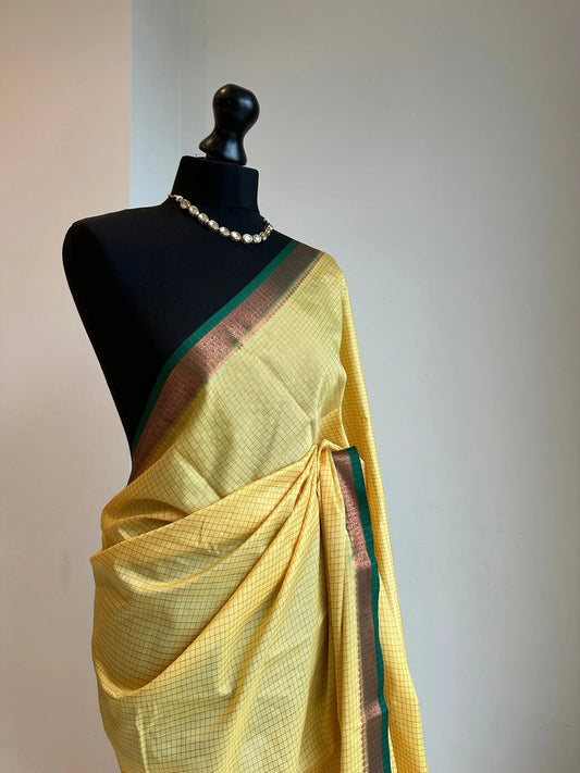 Yellow and green crepe binny silk saree with  contrast border, pallu and blouse. Beautiful checks  gives a stylish twist to this saree - LaiLai Sarees