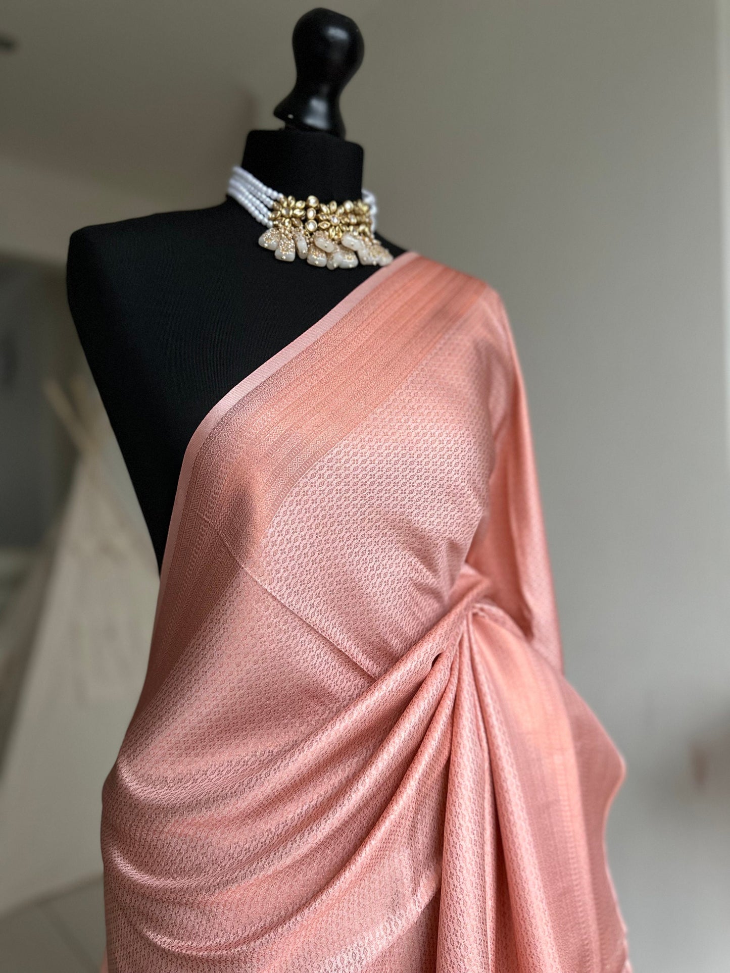 Pink soft silk saree with a copper border and all over sheen. The perfect saree for parties and all traditional events. Versatile saree