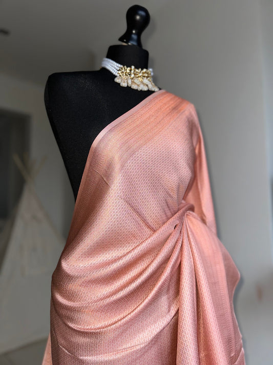 Pink soft silk saree with a copper border and all over sheen. The perfect saree for parties and all traditional events. Versatile saree