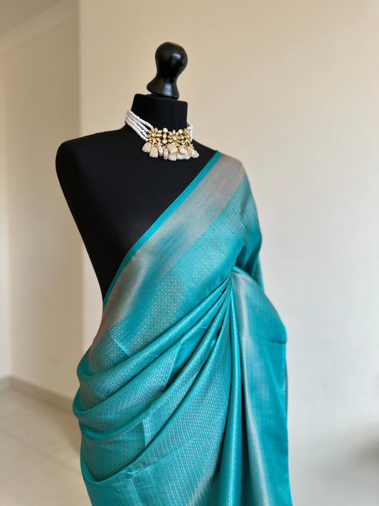 Sapphire blue  soft silk saree with a copper border and all over sheen. The perfect saree for parties and all traditional events.