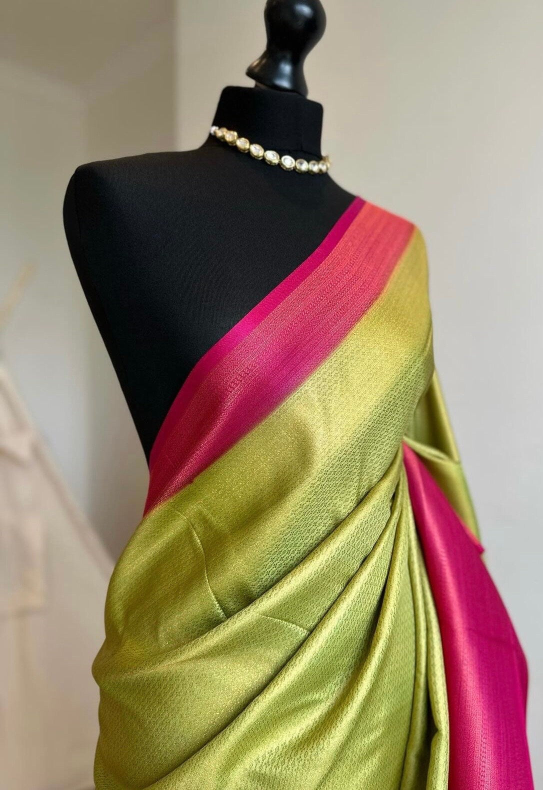 Pink and green soft silk saree with a copper border and all over sheen. The perfect saree for parties and all traditional events.