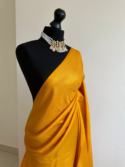 Mustard soft silk saree with a copper border and all over sheen. The perfect saree for parties and all traditional events.Pallu with tassels