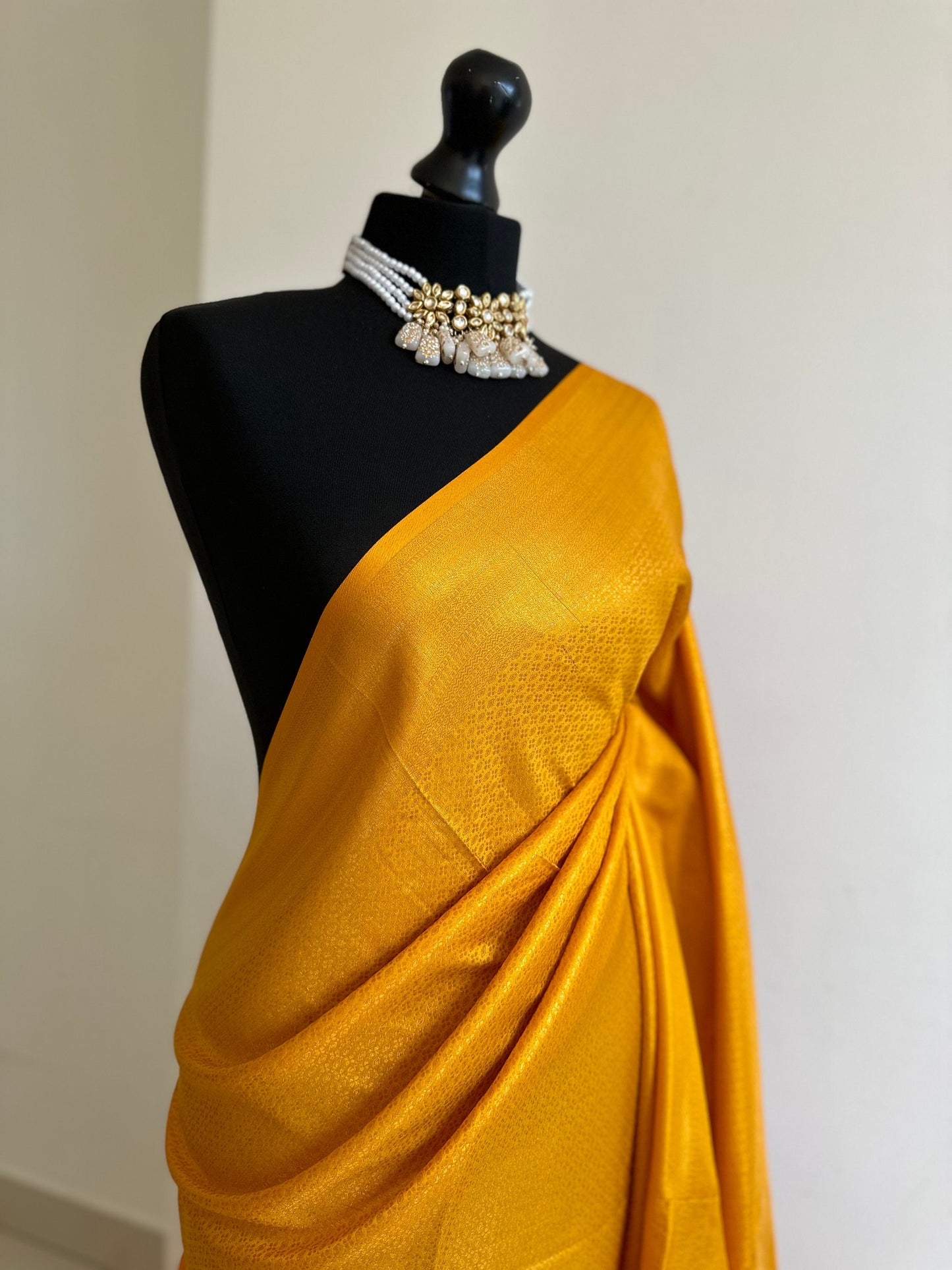 Mustard soft silk saree with a copper border and all over sheen. The perfect saree for parties and all traditional events.Pallu with tassels