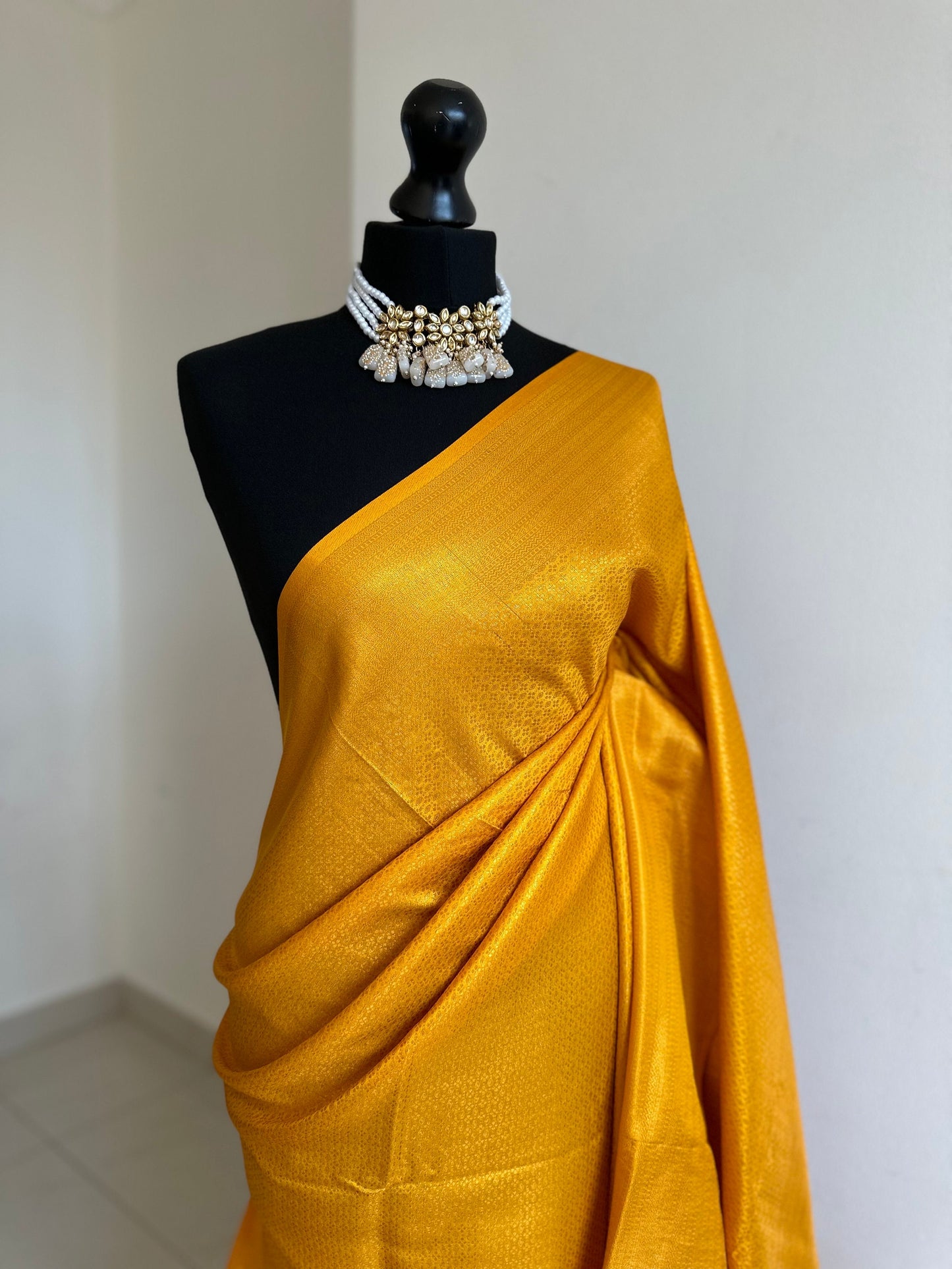 Mustard soft silk saree with a copper border and all over sheen. The perfect saree for parties and all traditional events.Pallu with tassels