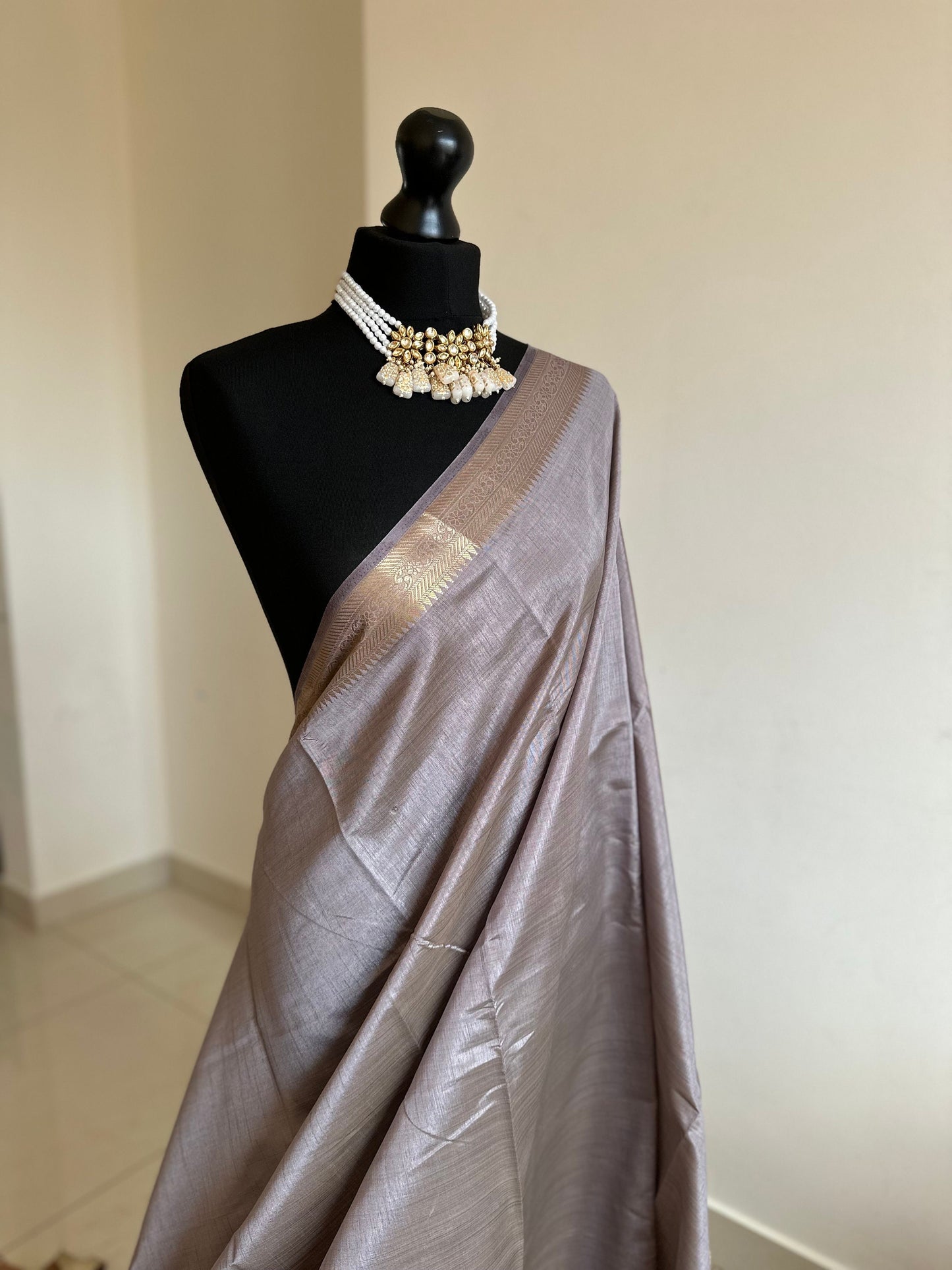 Grey soft tussar raw silk saree with unstitched blouse. Gold work on border and pallu. Statement saree and colour.