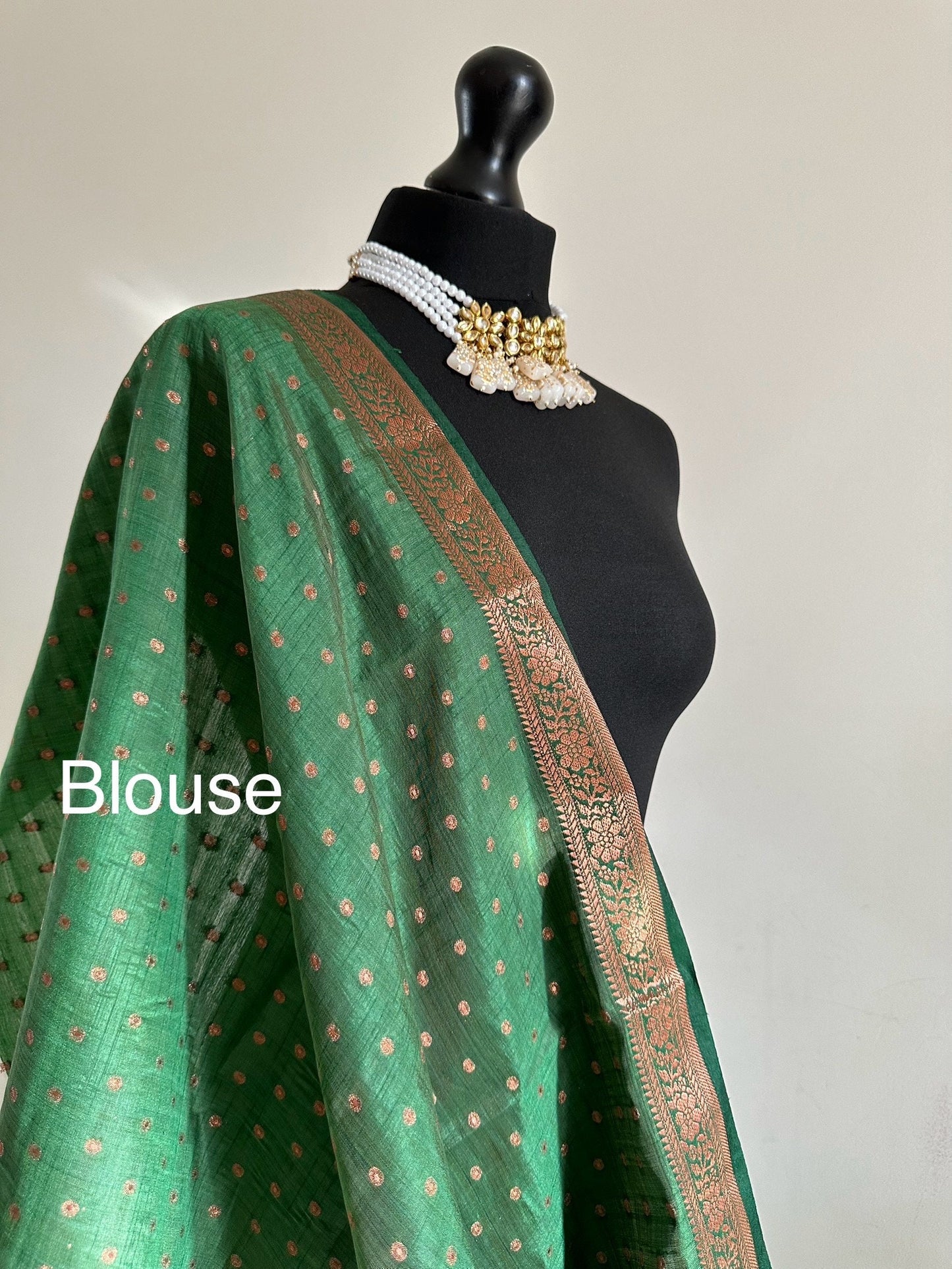 Dark green soft raw tussar silk saree with border and unstitched blouse. Copper work all over and border. Statement saree and colour