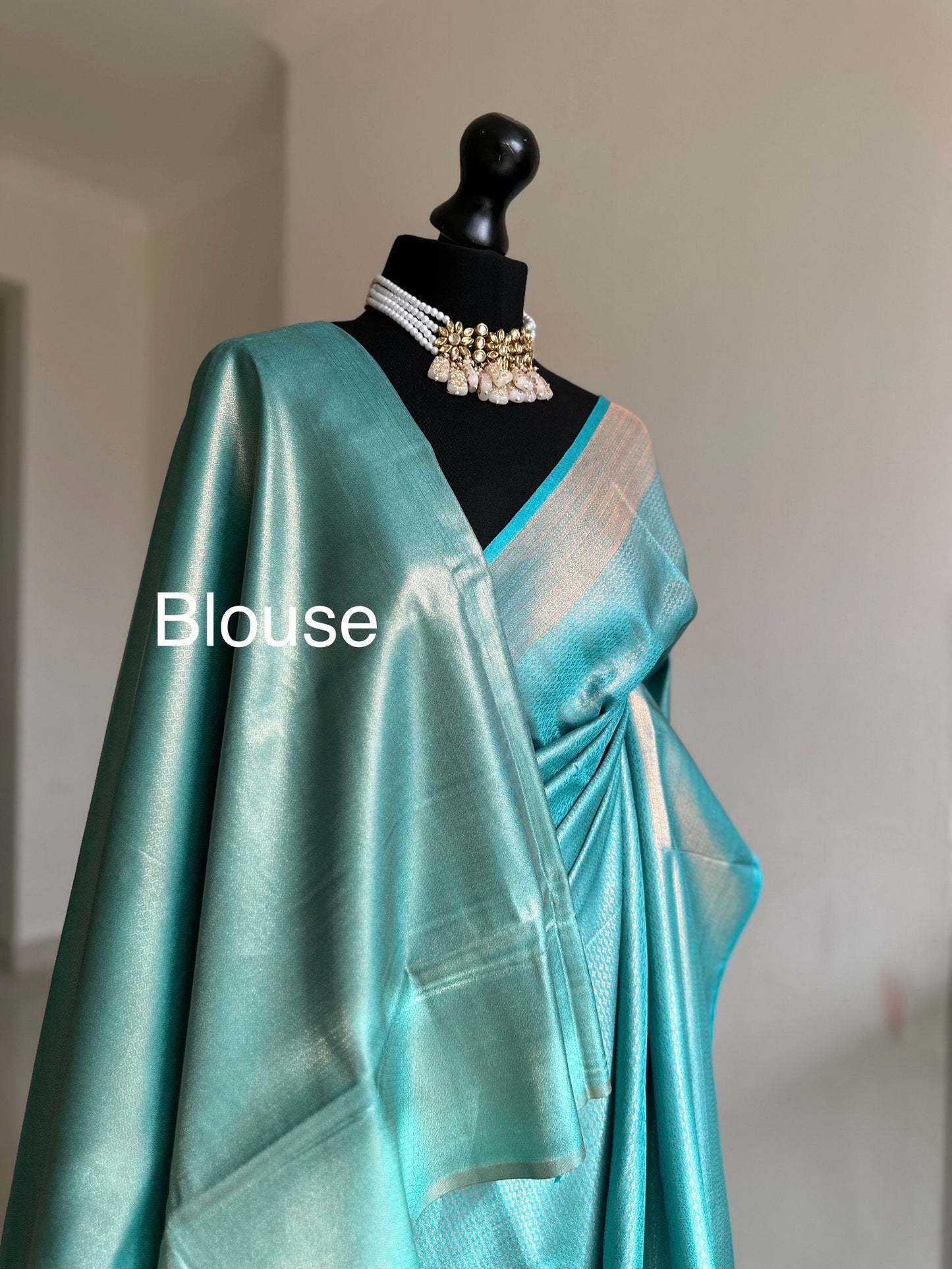 Light blue aqua soft silk saree with a copper border and all over sheen. The perfect saree for parties and all traditional events.