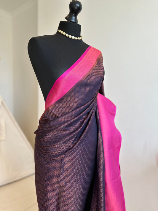 Navy and hot pinksoft silk saree with a copper border and all over sheen. The perfect saree for parties and all traditional events.