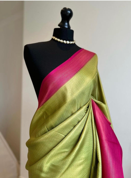 Pink and green soft silk saree with a copper border and all over sheen. The perfect saree for parties and all traditional events.