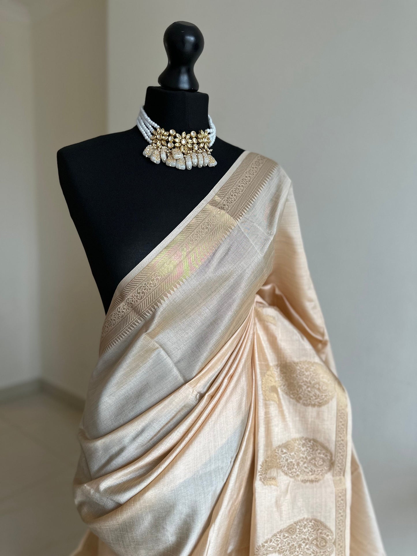 Cream soft tussar raw silk saree with unstitched blouse. Gold work on border and pallu. Statement saree and colour.