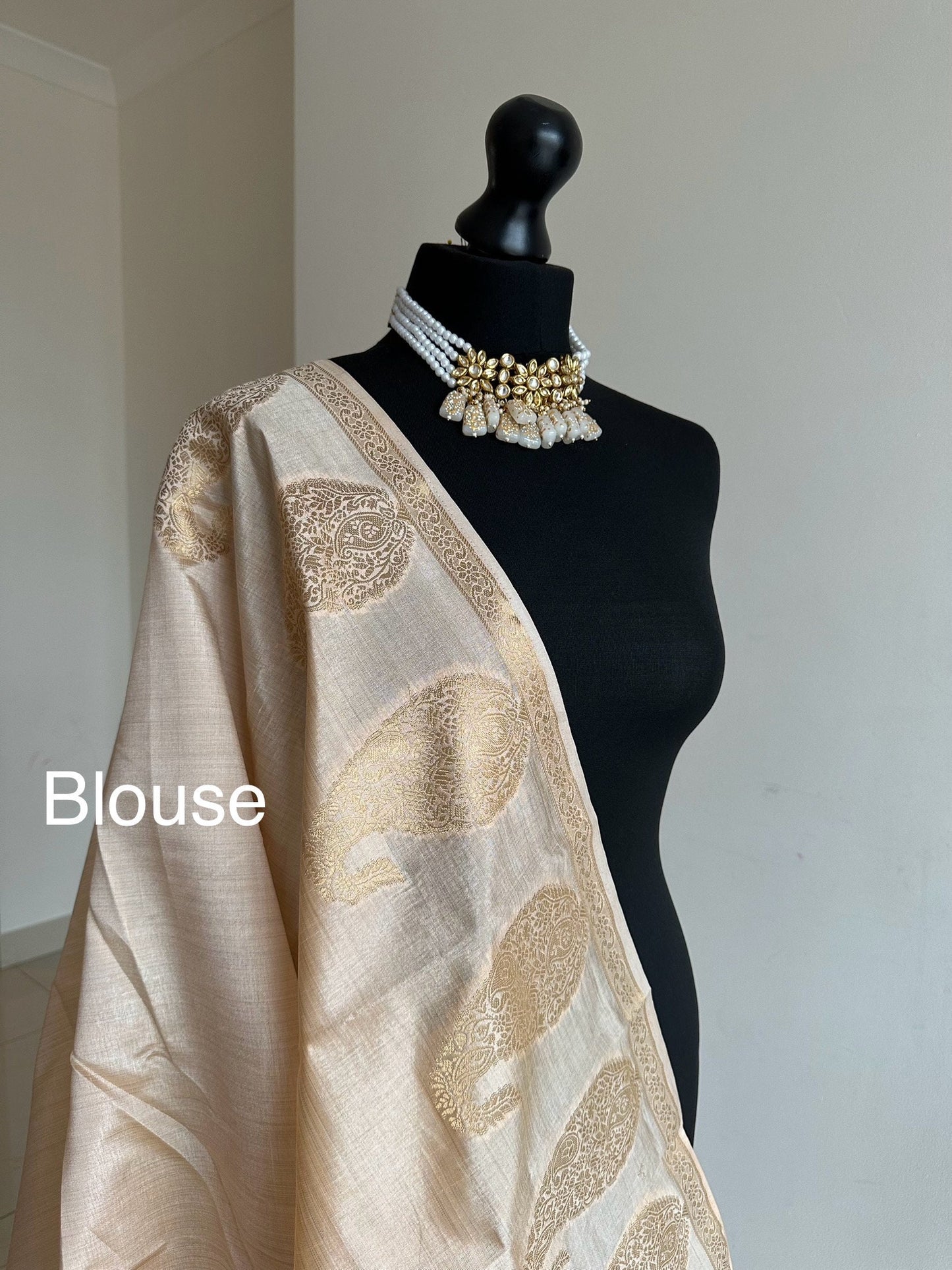 Cream soft tussar raw silk saree with unstitched blouse. Gold work on border and pallu. Statement saree and colour.