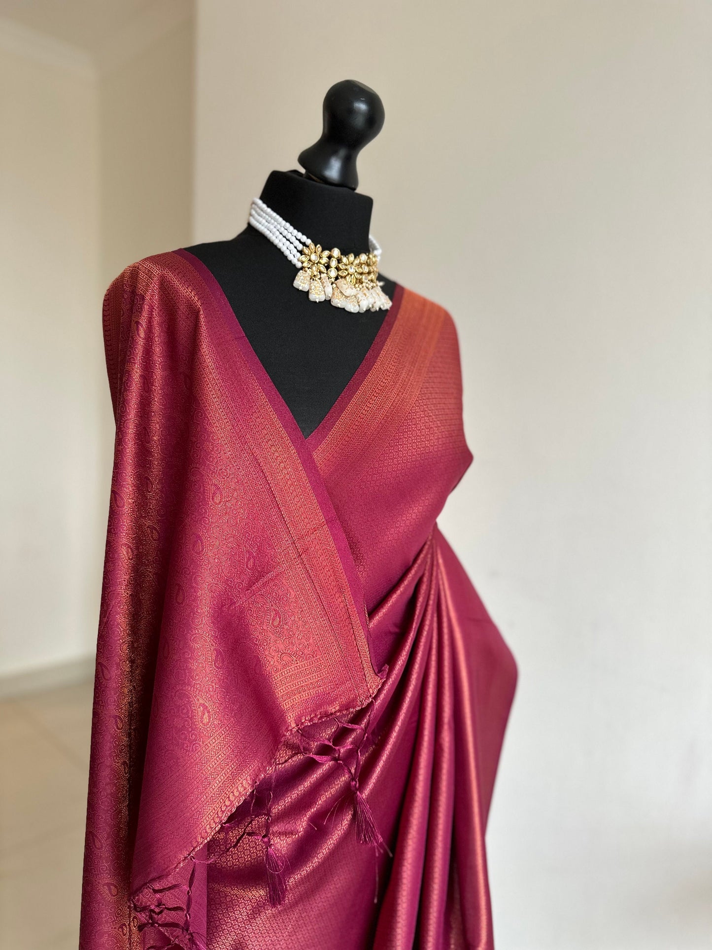 Wine burgundy soft silk saree with copper border and all over sheen. The perfect saree for parties all traditional events.Versatile saree