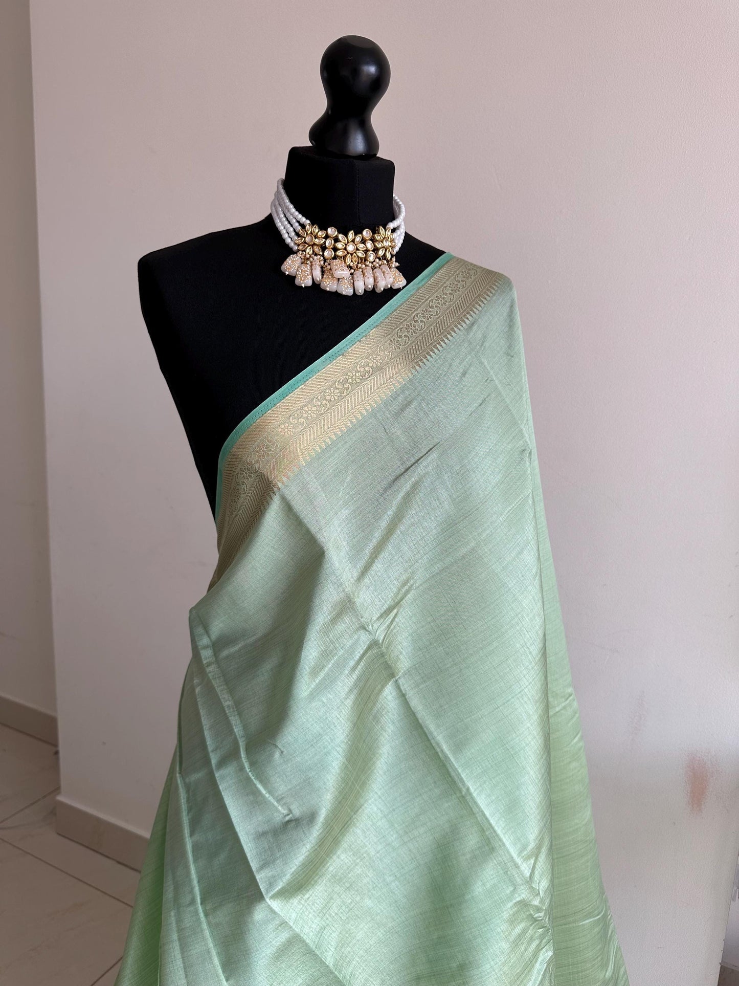 Mint green soft tussar raw silk saree with unstitched blouse. Gold work on border and pallu. Statement saree and colour.