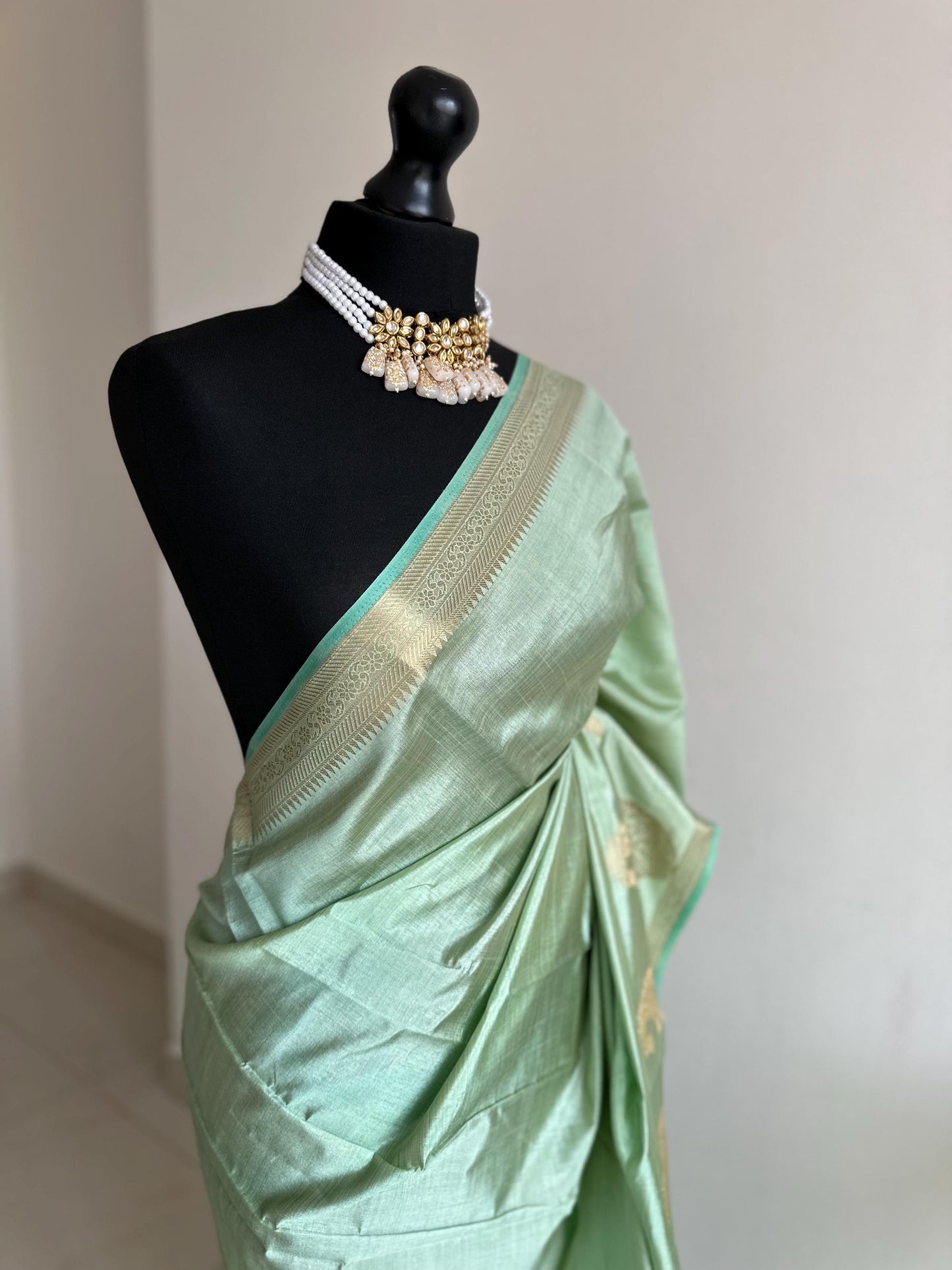 Mint green soft tussar raw silk saree with unstitched blouse. Gold work on border and pallu. Statement saree and colour.