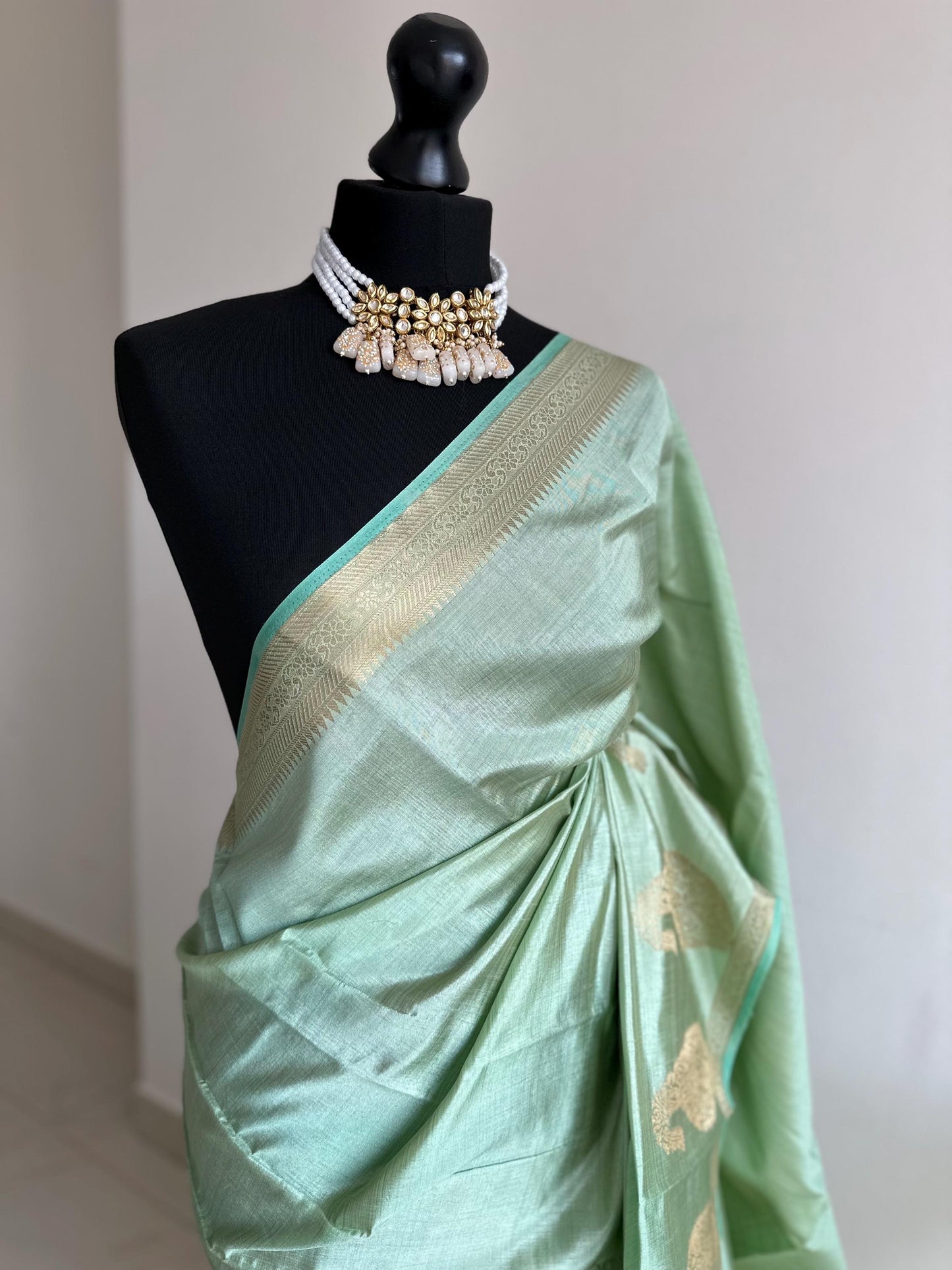 Mint green soft tussar raw silk saree with unstitched blouse. Gold work on border and pallu. Statement saree and colour.