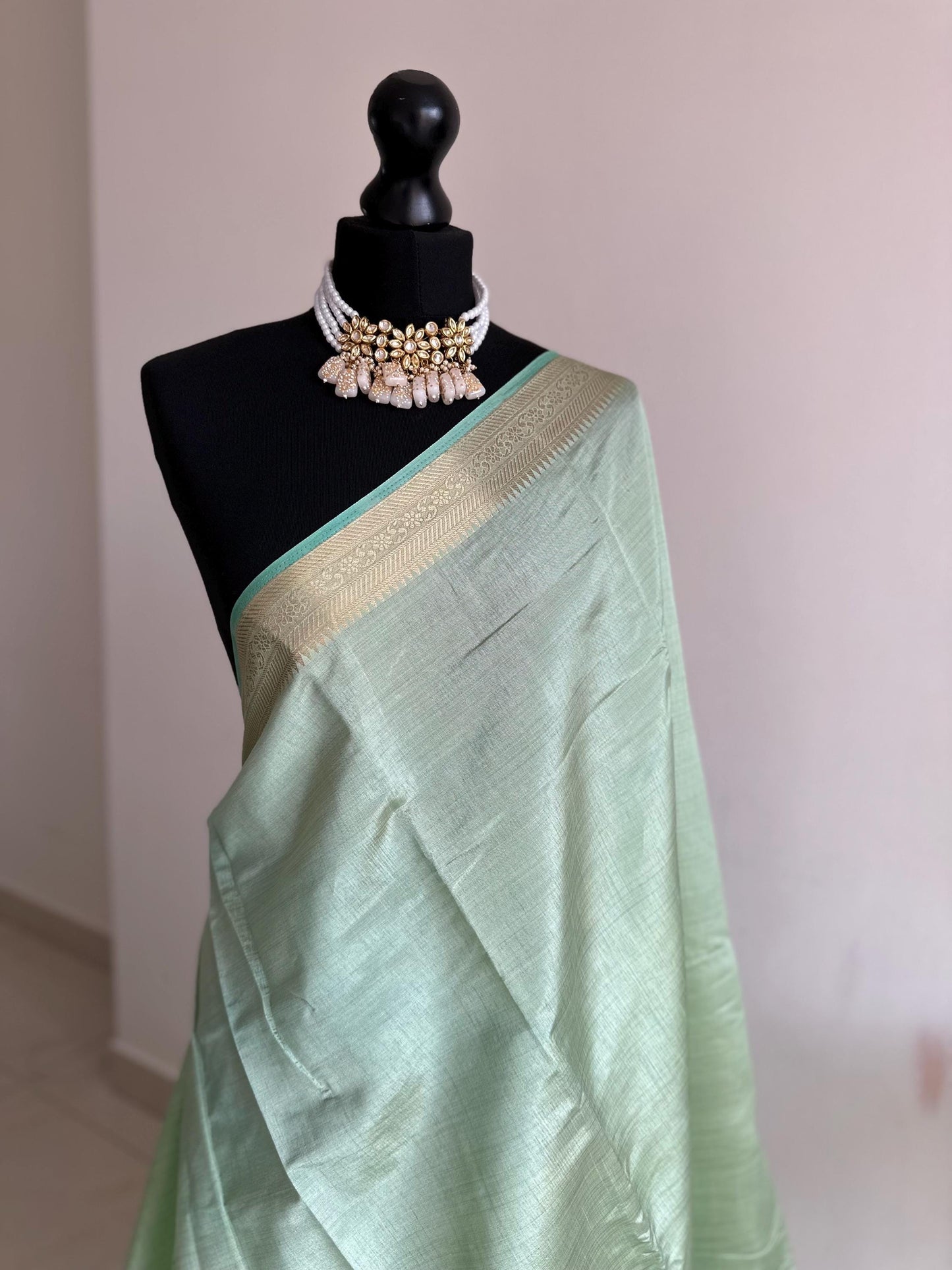 Mint green soft tussar raw silk saree with unstitched blouse. Gold work on border and pallu. Statement saree and colour.