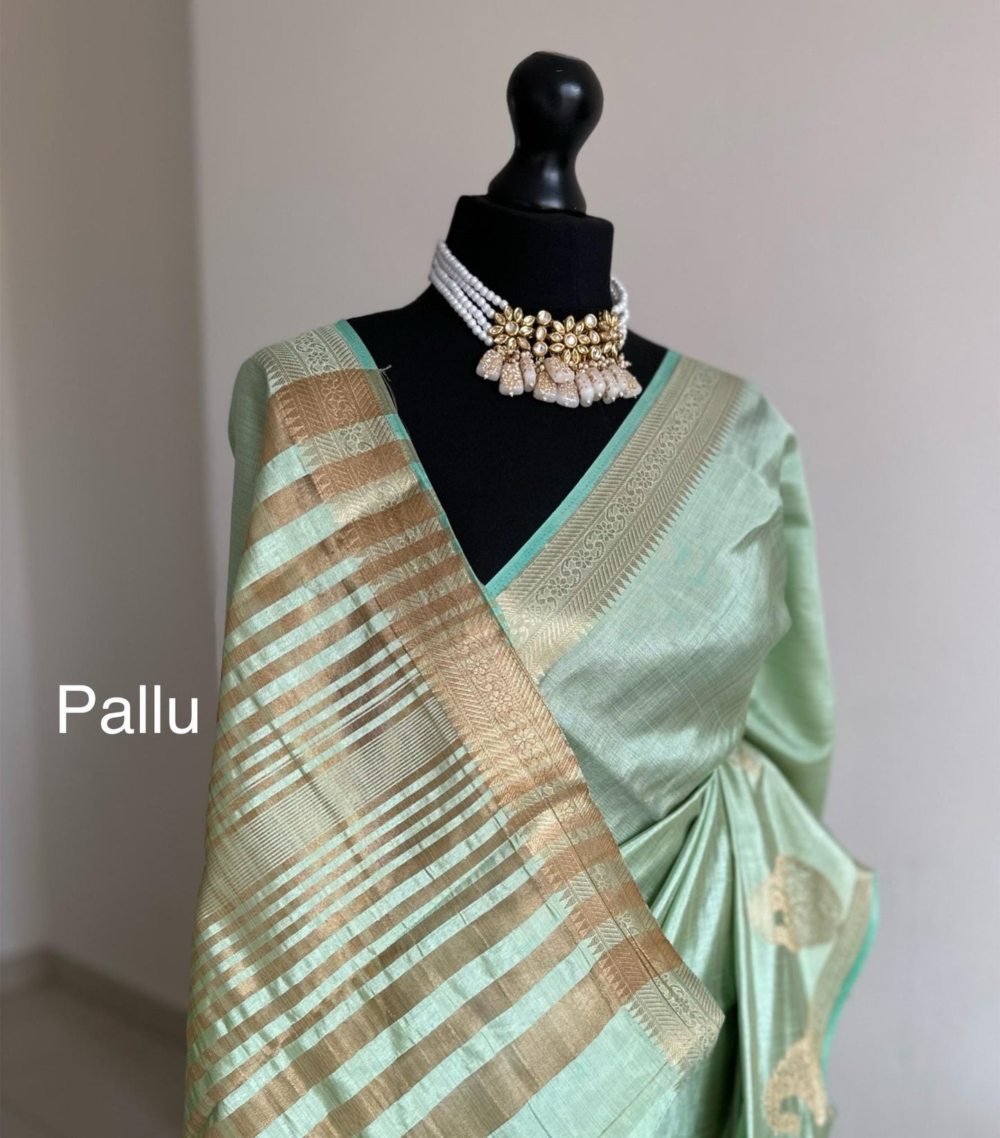 Mint green soft tussar raw silk saree with unstitched blouse. Gold work on border and pallu. Statement saree and colour.