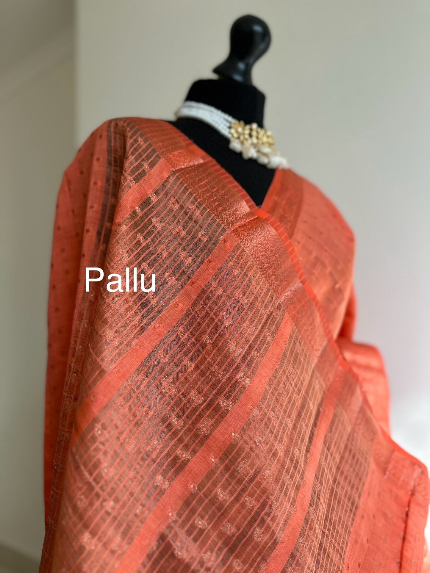 Orange coral soft tussar silk saree with border and unstitched blouse. Copper work all over and border. Statement saree and colour,stand out