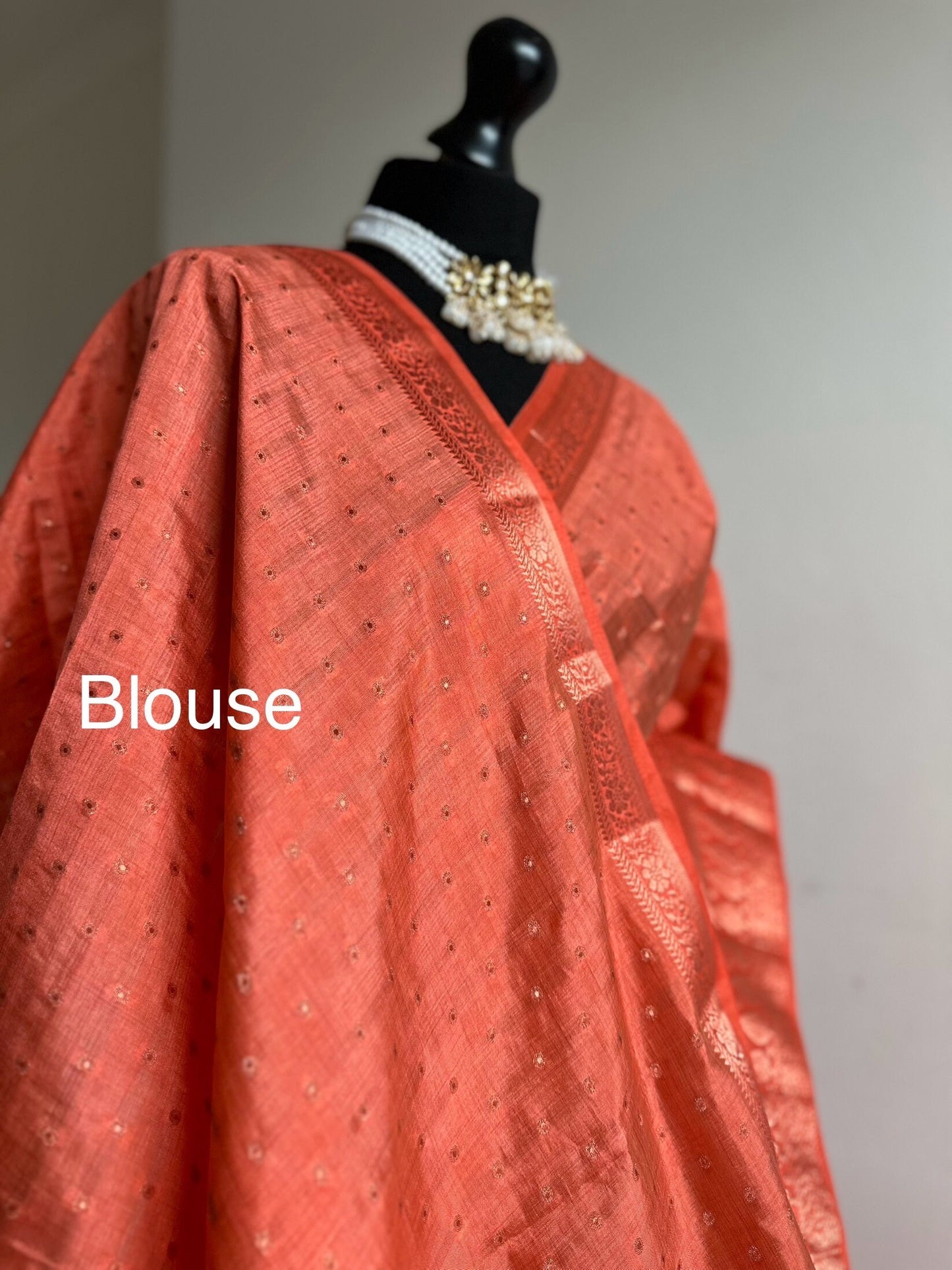 Orange coral soft tussar silk saree with border and unstitched blouse. Copper work all over and border. Statement saree and colour,stand out