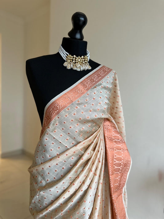 Cream and copper soft tussar silk saree with unstitched blouse. Copper work all over and border. Statement saree and colour.