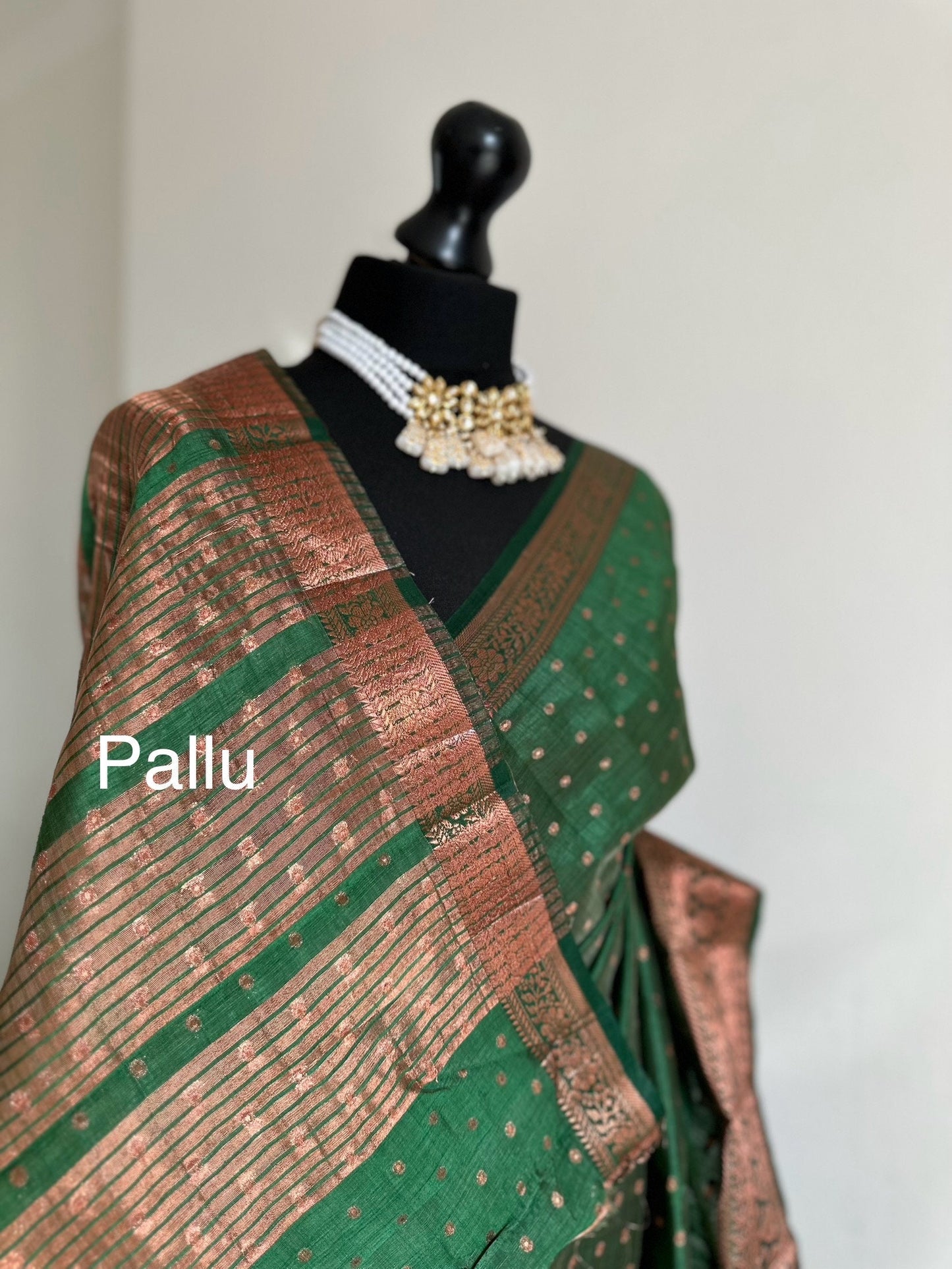 Dark green soft raw tussar silk saree with border and unstitched blouse. Copper work all over and border. Statement saree and colour