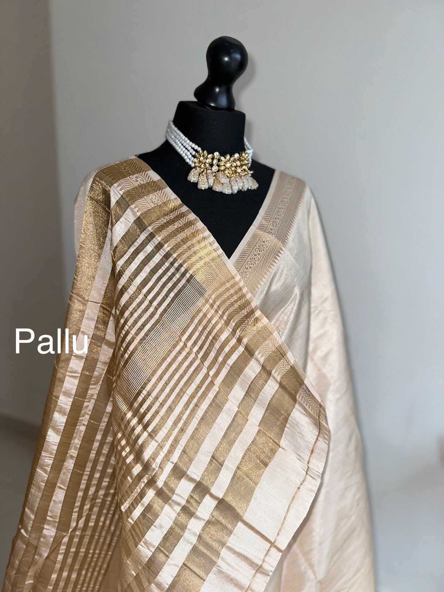 Cream soft tussar raw silk saree with unstitched blouse. Gold work on border and pallu. Statement saree and colour.