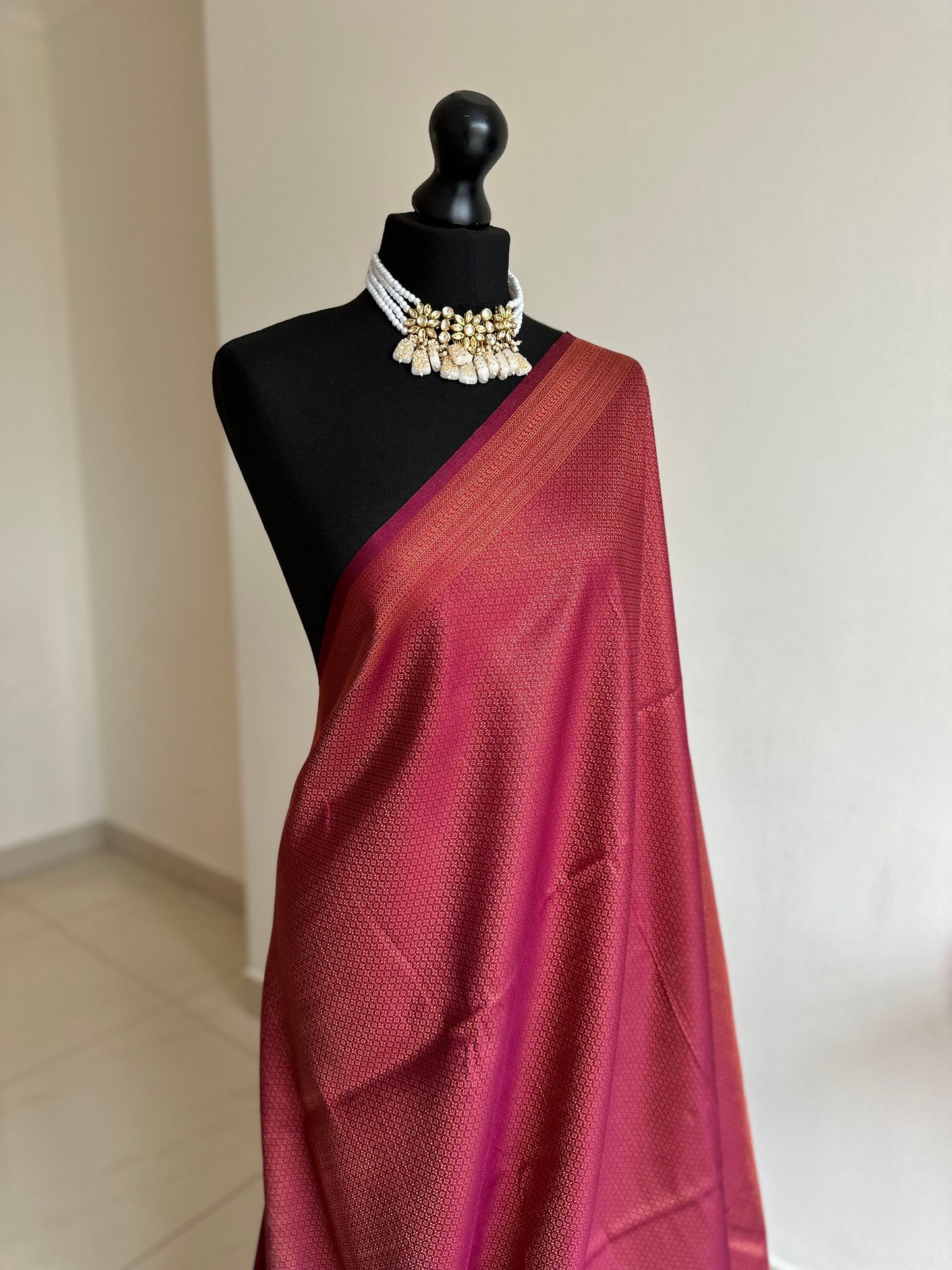 Wine burgundy soft silk saree with copper border and all over sheen. The perfect saree for parties all traditional events.Versatile saree