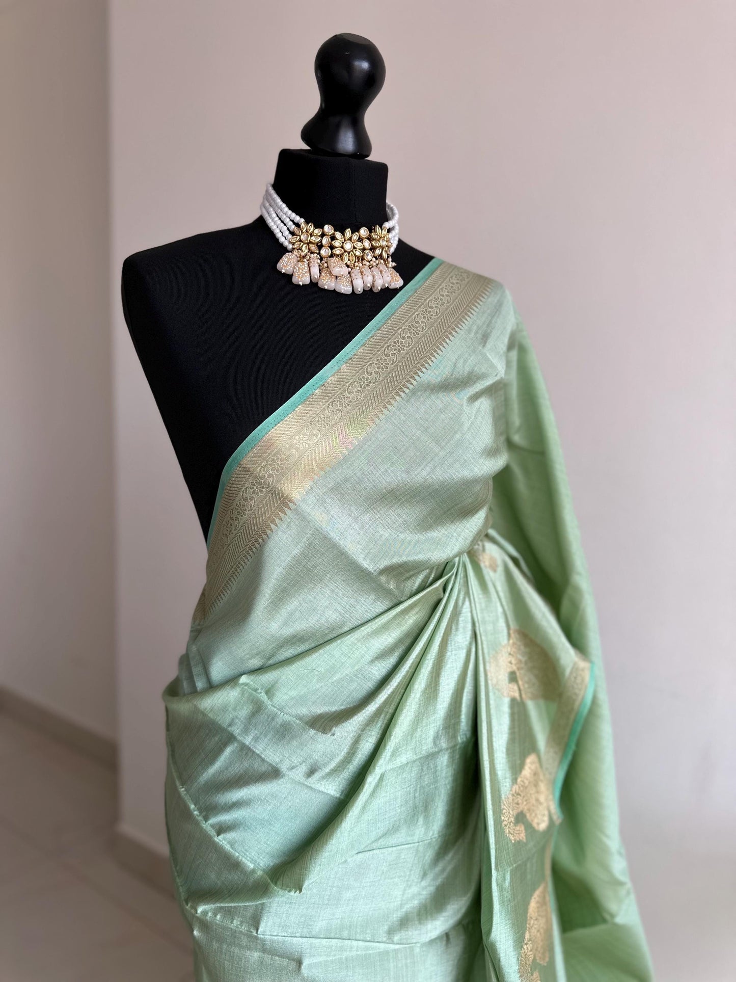 Mint green soft tussar raw silk saree with unstitched blouse. Gold work on border and pallu. Statement saree and colour.